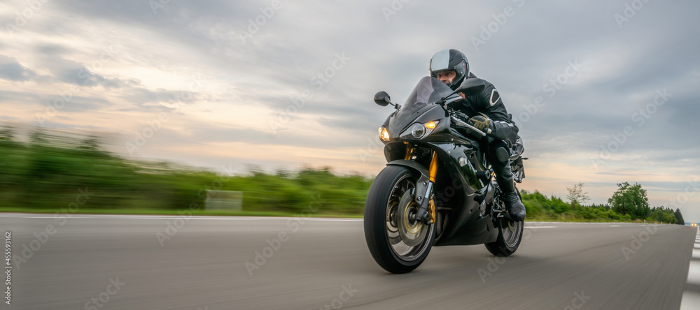 motorbike on the road riding. having fun riding the empty road on a motorcycle tour / journey