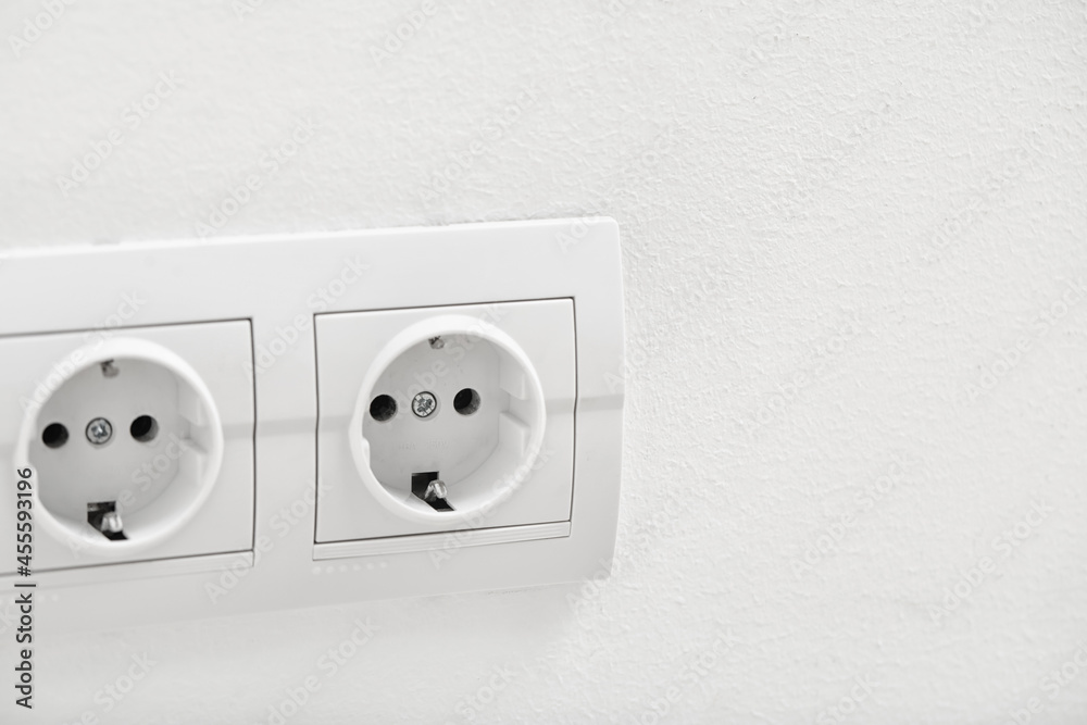 Electric socket on light wall Electric socket on light wall