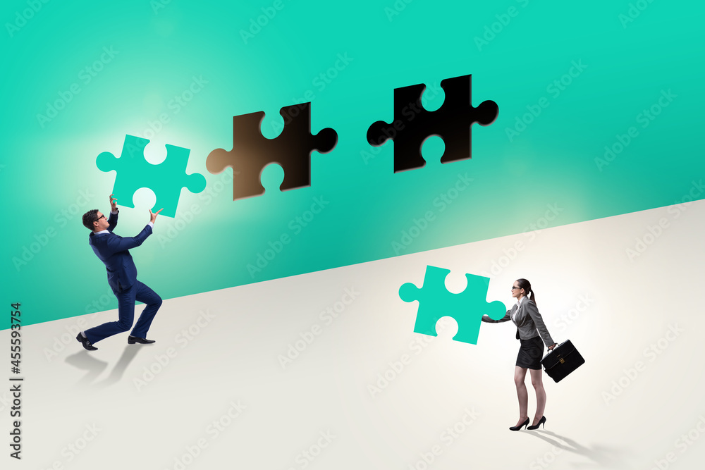 Businessman putting missing jigsaw puzzle piece Businessman putting missing jigsaw puzzle piece