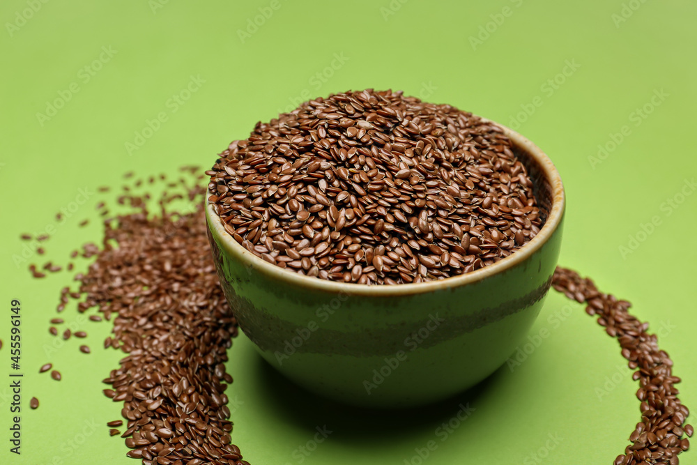 Bowl with flax seeds on color background, closeup Bowl with flax seeds on color background, closeup