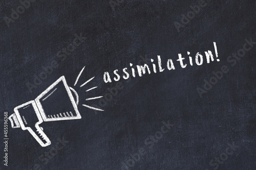 Chalk loudspeaker and inscription assimilation on black chalkboard