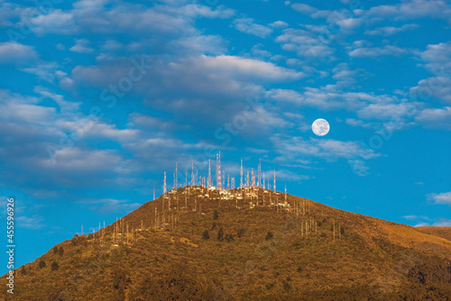 Full moon by Pichincha volcano at sunrise, Quito, Ecuador.