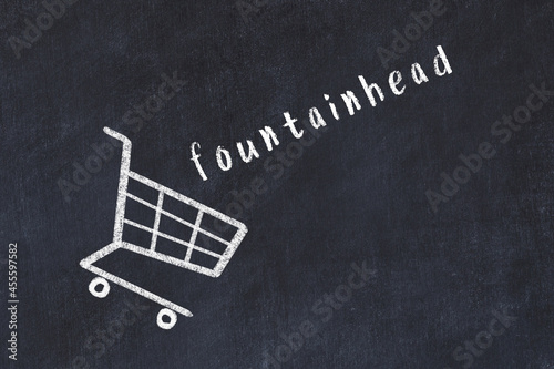 Chalk drawing of shopping cart and word fountainhead on black chalboard. Concept of globalization and mass consuming photo