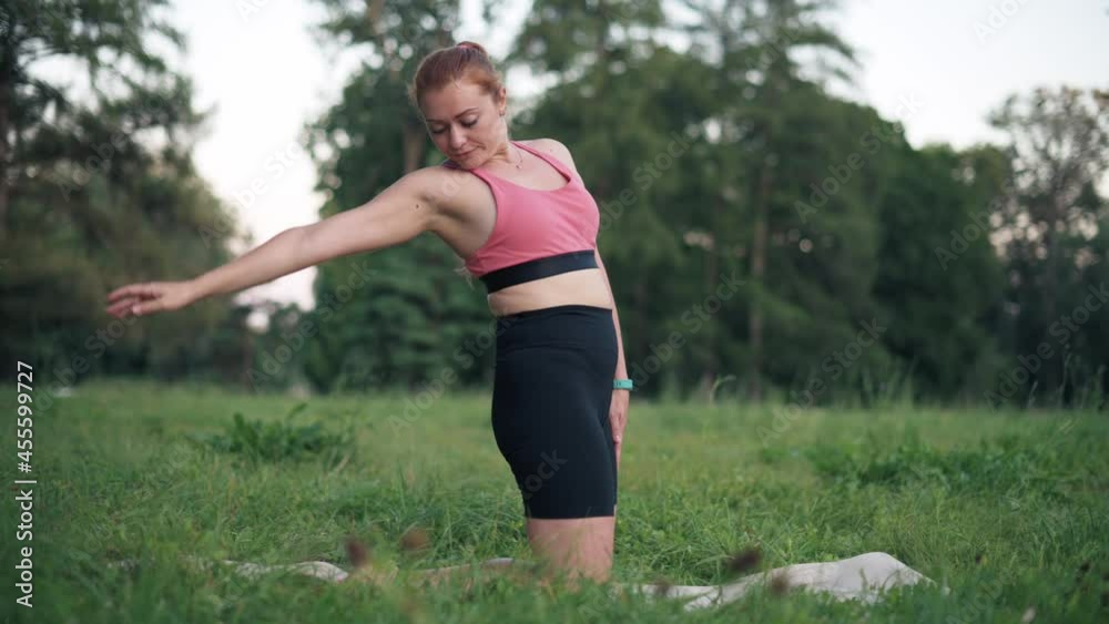 Young woman in sportswear practices yoga in nature. Exercise for body flexibility. Young woman in sportswear practices yoga in nature. Exercise for body flexibility.