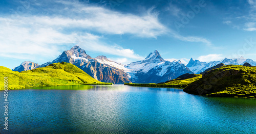Panorama of Bachalpsee lake in Swiss Alps mountains. Snowy peaks of Wetterhorn, Mittelhorn and Rosenhorn on background. Grindelwald valley, Switzerland. Landscape photography photo