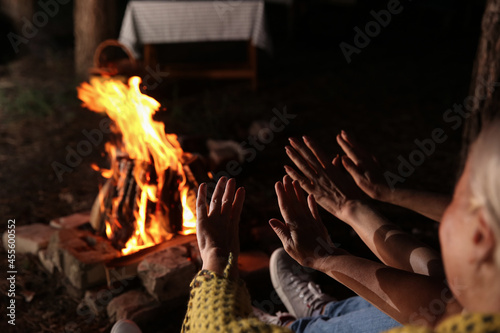 Mature women warming hands ...