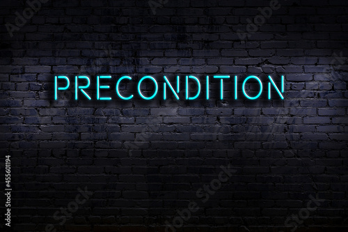 Night view of neon sign on brick wall with inscription precondition photo