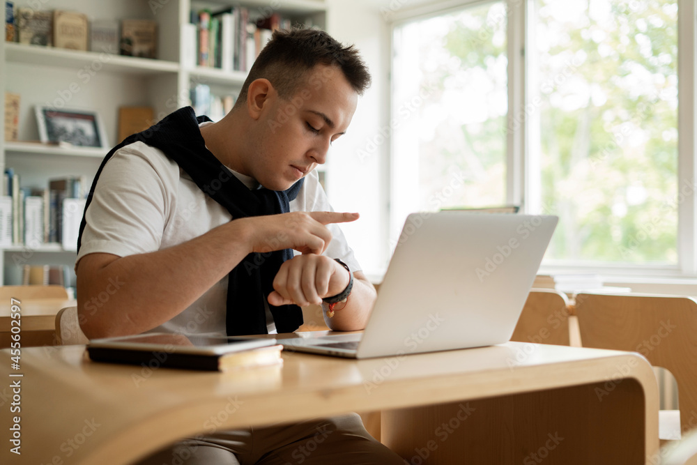 The student studies online lessons on the institute's website. A smart man to study at the institute. Reads an e-book in the university library. Surf the Internet in between classes. The student studies online lessons on the institute's website. A smart man to study at the institute. Reads an e-book in the university library. Surf the Internet in between classes.