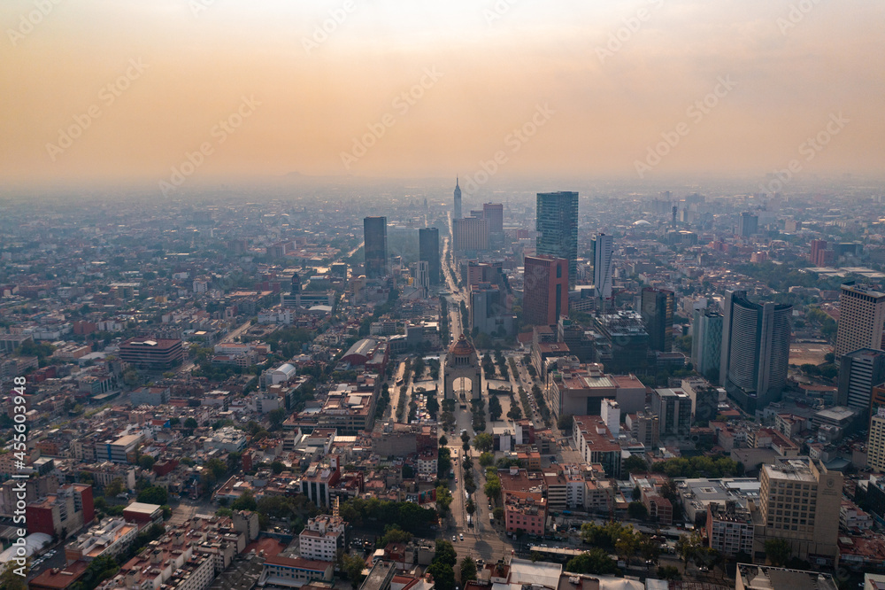 Panoramic aerial view of the gardens and the monument to the revolution with a beautiful sunset background in the center of Mexico City with orange sky