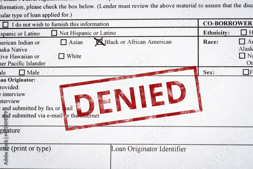 Image of a generic mortgage application with black and African American box marked and a red denied stamp on it.