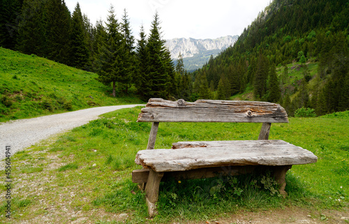 beautiful view of an old wooden bench and a hiking trail leading to the picturesque Edenbachalpe in the Tannheim Valley or Tannheimer Tal ot Tannheim, Austria