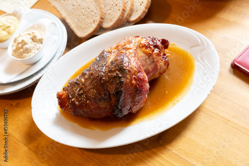 Traditional czech dish of roasted pork shank served in gravy with horseradish, mustard and bread