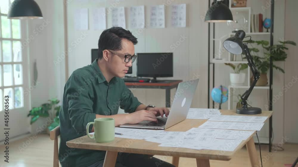 Asian Man Works With Laptop Computer And Storyboard. Video Editing, Comics Compilation, Application Ui Or Game Plot
Asian Man Works With Laptop Computer And Storyboard. Video Editing, Comics Compilation, Application Ui Or Game Plot