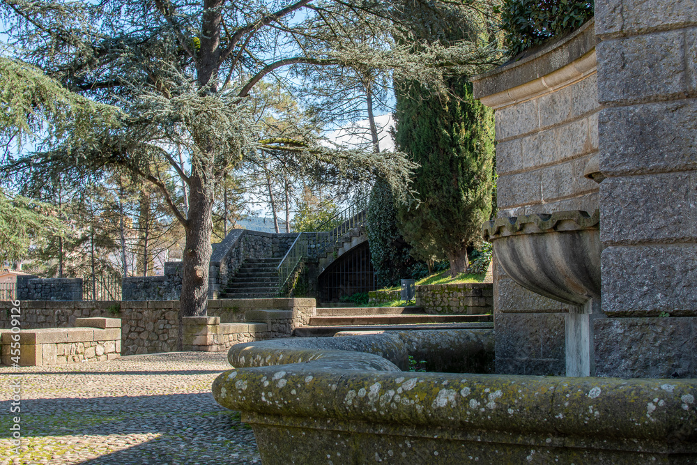 Solitary park with gardens and a stone fountain in Girona
