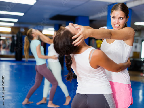 Young lady doing eye-gouging movement during group self-defence class.