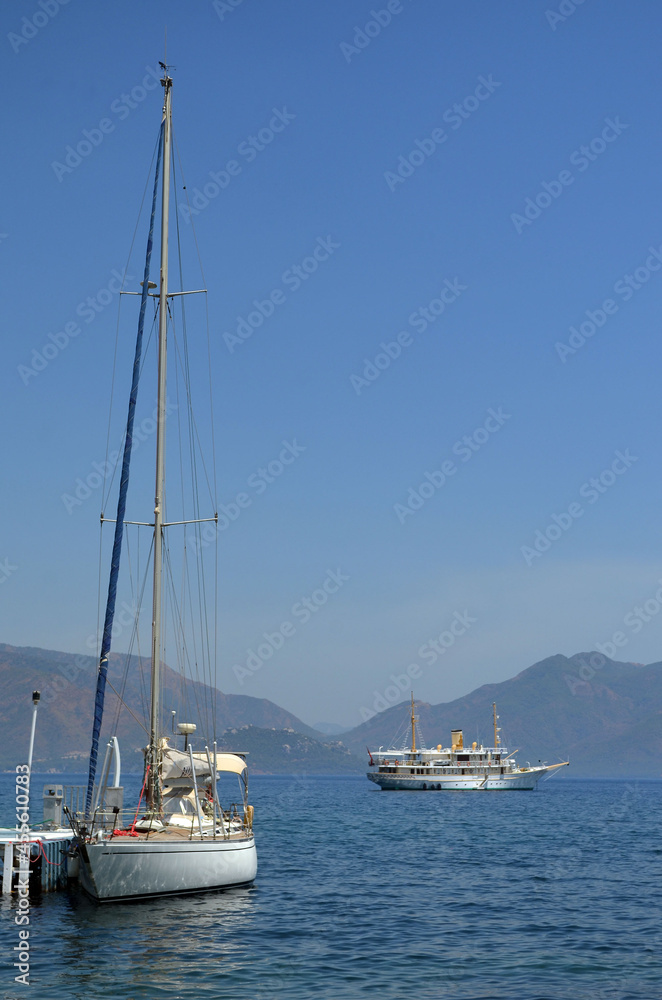 Yachts in bay of Marmaris on background of mountain islands in mist. Summer seascape in Aegean sea