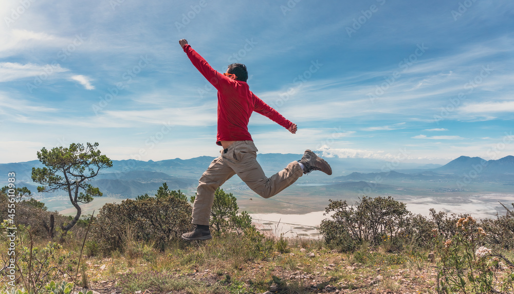 man jumping over rocks in mountain man jumping over rocks in mountain