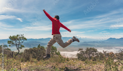 man jumping over rocks in mountain