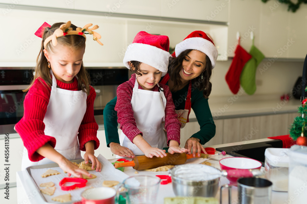 Mother teaching her children how to bake cookies Mother teaching her children how to bake cookies