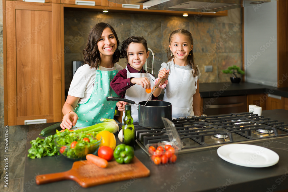 Adorable mother and kids in the kitchen