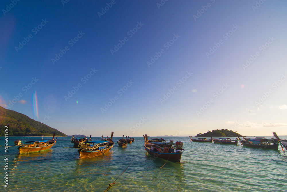 Wooden fishery travel boat on sea beach sunny day morning