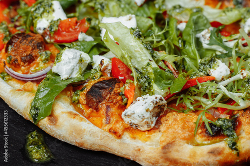 vegetarian pizza with cheese tomatoes and greens