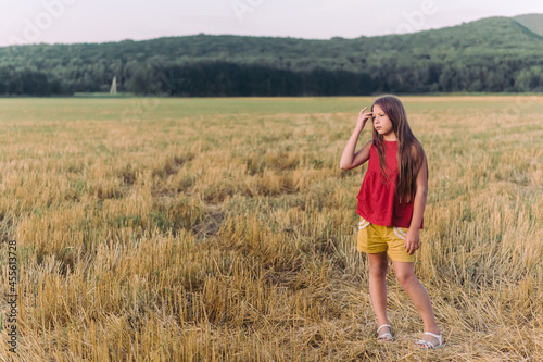 Side view portrait of happy beautiful girl breathing fresh air in field  outdoors. High quality photo