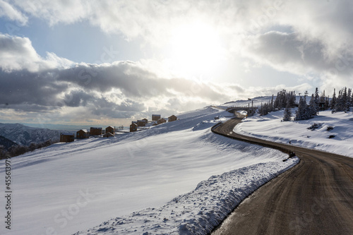 Winding snowy road into the sunset