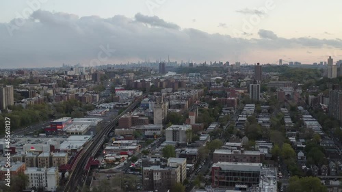 Aerial dolly shot during sunset with city, cars and outdoor train