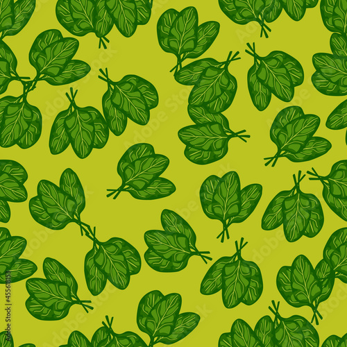 Seamless pattern bunch spinach salad on bright green background. Modern ornament with lettuce.