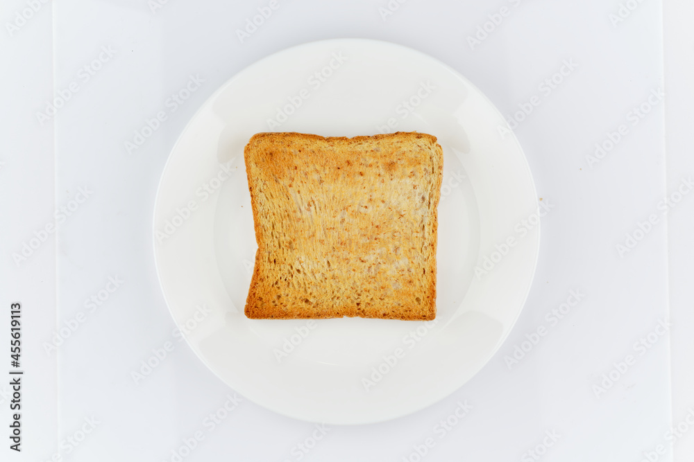 flat lay top view of golden crunchy toasted sliced whole wheat sandwich bread isolated on white dish and white background