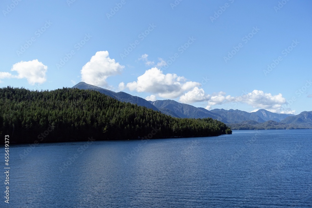 Majestic views of the forested mountains and beautiful blue ocean along the british columbia coast along the BC ferries inside passage route, on a beautiful sunny day Majestic views of the forested mountains and beautiful blue ocean along the british columbia coast along the BC ferries inside passage route, on a beautiful sunny day