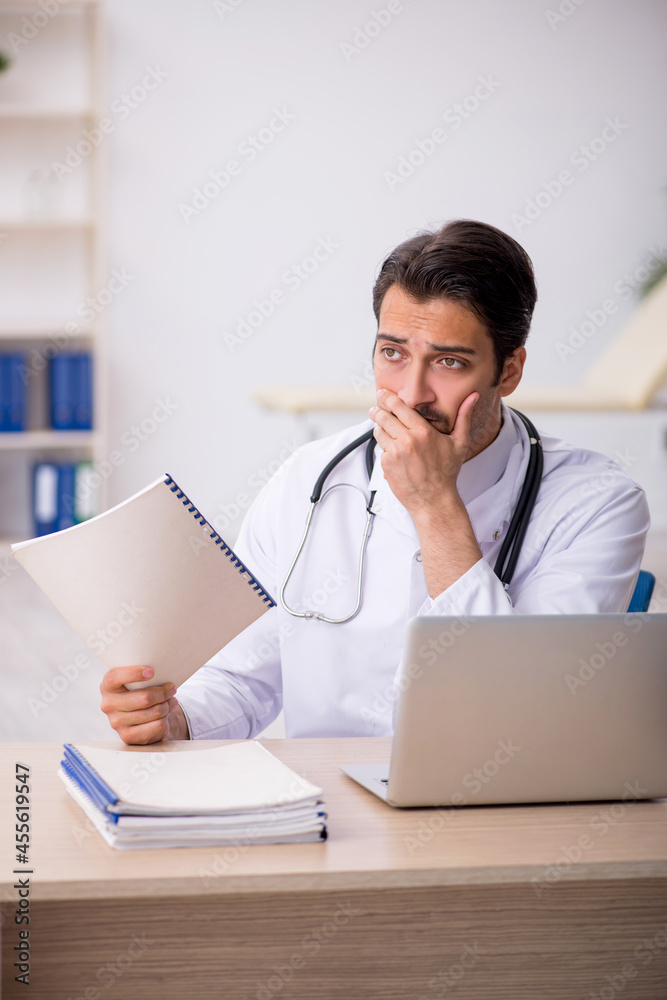Young male doctor working in the clinic Young male doctor working in the clinic