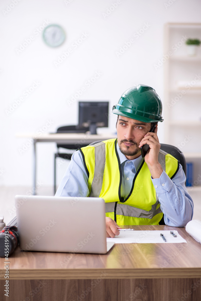 Young male architect working in the office Young male architect working in the office
