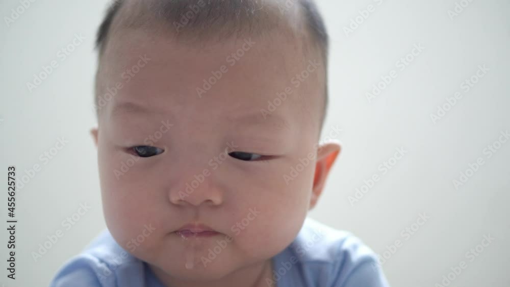 Close up baby face drool at white background Close up baby face drool at white background