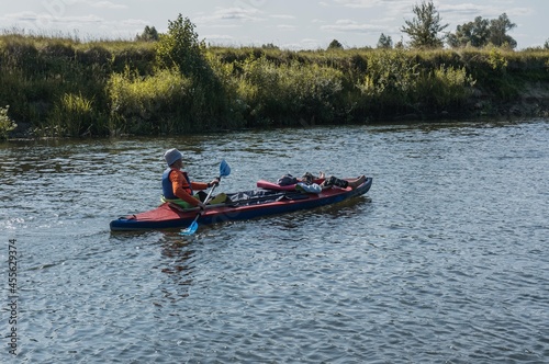 a man on a kayak floats on the river © vulkanov