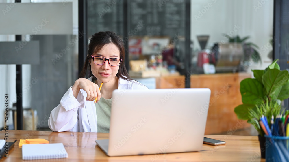 Asian woman freelancer working with computer laptop at cafe. Asian woman freelancer working with computer laptop at cafe.
