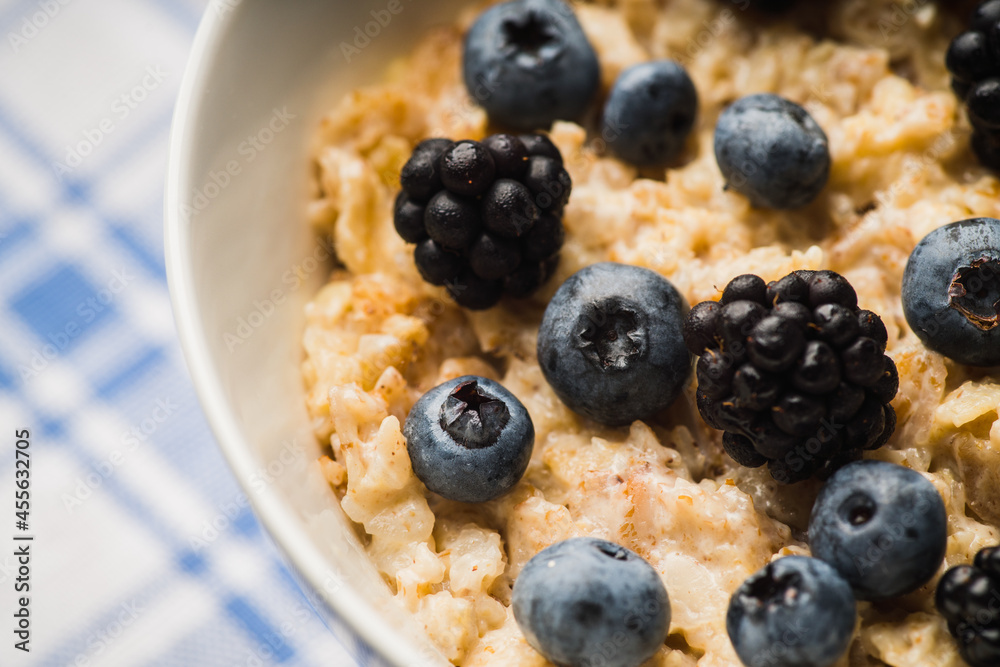 Oatmeal porridge with berries. Selective focus.