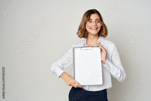 cheerful business woman in white shirt office work light background