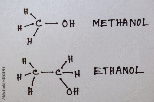 Chemical structure of methanol and ethanol handwritten on white page. 