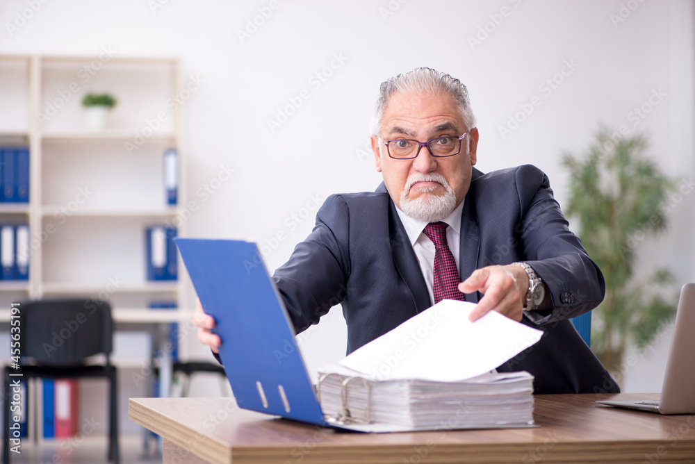Old male employee and too much work in the office Old male employee and too much work in the office