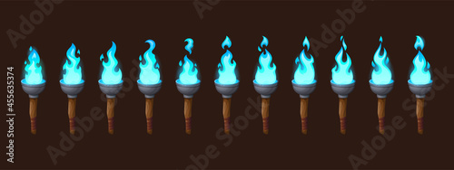 Burning fire on old torch for video game. Vector cartoon animation sprite sheet with sequence of magic blue flame on ancient wood and metal torch isolated on dark background