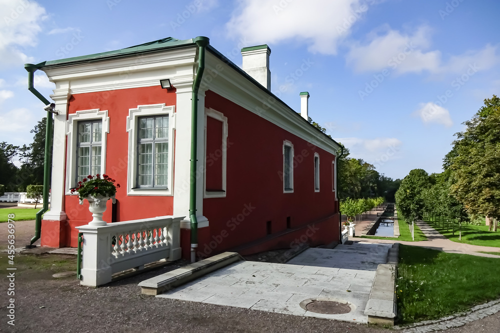 View to red and white small house in green Kadriorg park on a summer day. Blue clear sky. Stairs down. August 2021. Tallinn, Estonia, Europe