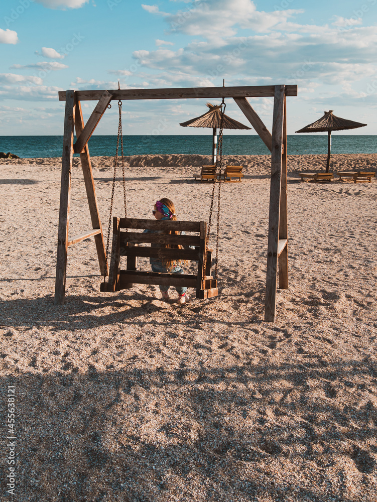Little girl chilling resting in beach swing. Happy child smiling relaxing enjoying life sun fresh air. Lifestyle travel real people outdoor. Having fun vacation. Freedom happiness distance e-learning. Little girl chilling resting in beach swing. Happy child smiling relaxing enjoying life sun fresh air. Lifestyle travel real people outdoor. Having fun vacation. Freedom happiness distance e-learning.