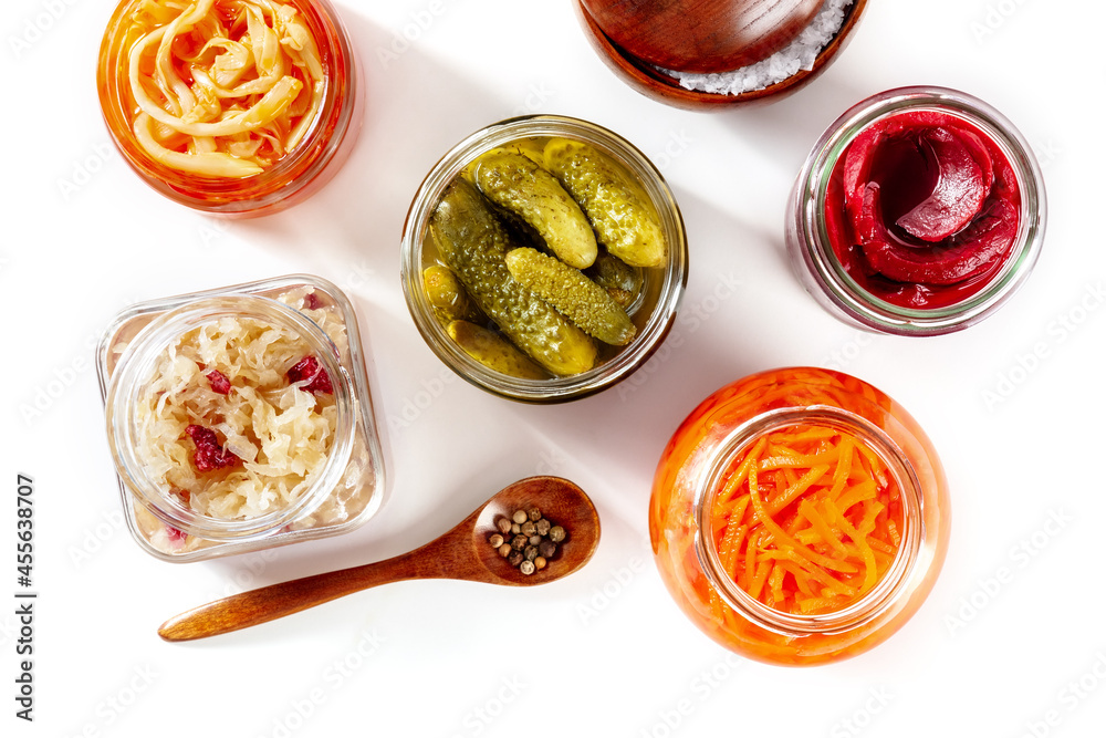 Fermented food on a white background. Canned sauerkraut, carrot, pickles and other preserves in mason jars. Homemade vegan cooking. Probiotic foods