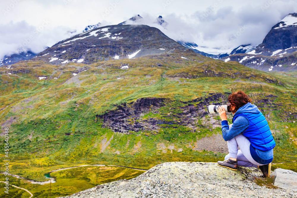 Tourist with camera in Norway mountains