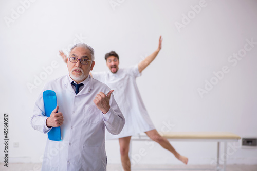 Old male doctor psychiatrist examining young male patient