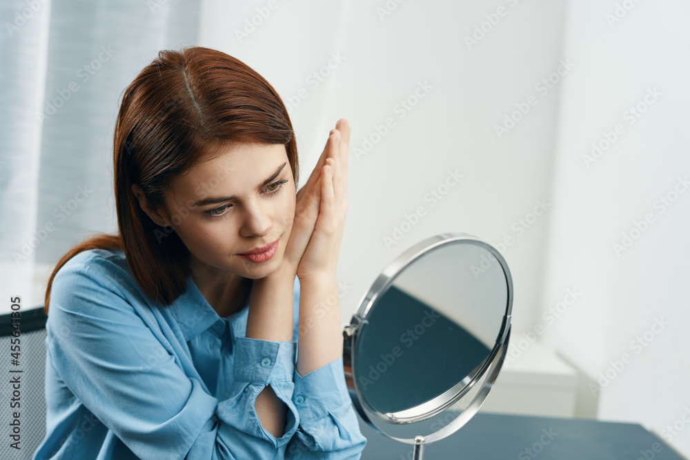 woman looks in the mirror hairstyle cosmetics morning clean skin woman looks in the mirror hairstyle cosmetics morning clean skin