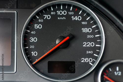 Speedometer in a car. Car dashboard. Dashboard details with indication lamps.Car instrument panel. Dashboard with speedometer.Car detailing. Modern interior.Closeup.Copy space.