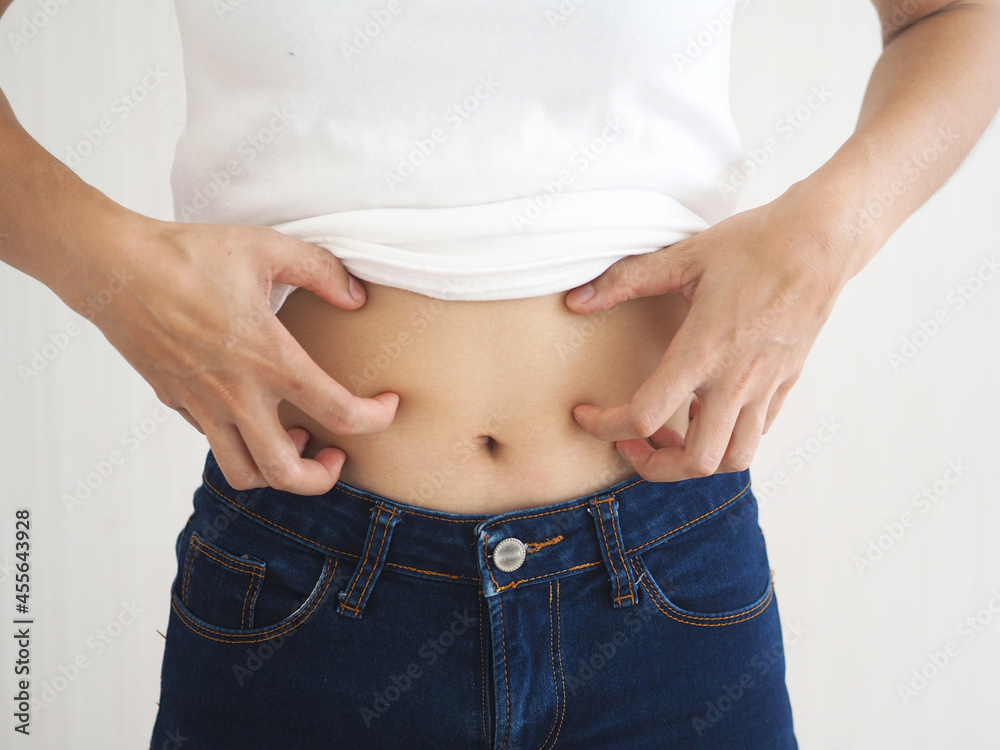 Asian woman scratching her stomach. caused by hives, insect bites ...
